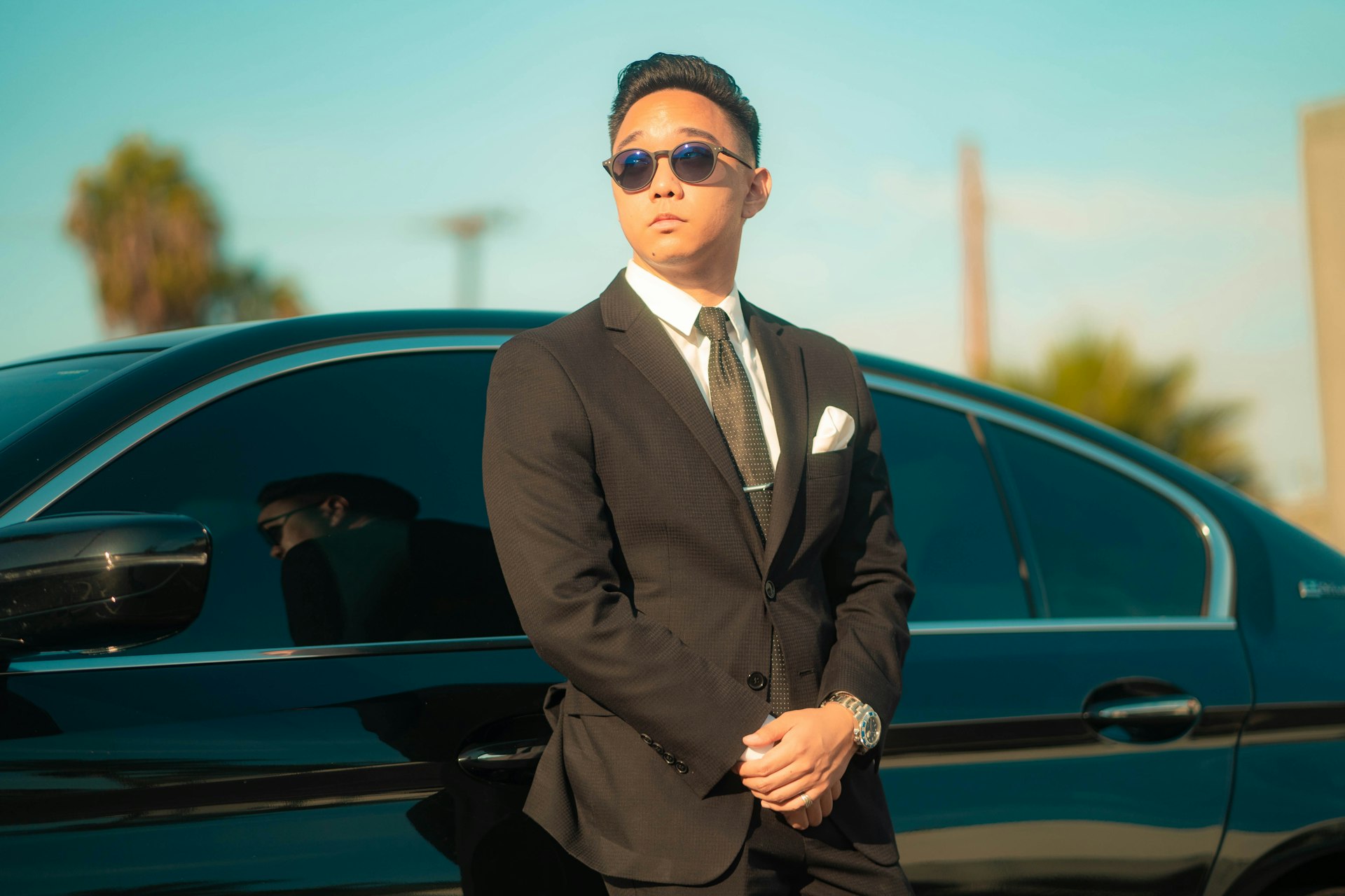 Black luxury SUV with suited chauffeur — Los Angeles